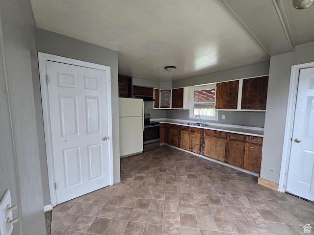 616 Jefferson St, Montpelier, ID 83254 - kitchen with electric range, freestanding refrigerator, a sink, light countertops, and under cabinet range hood