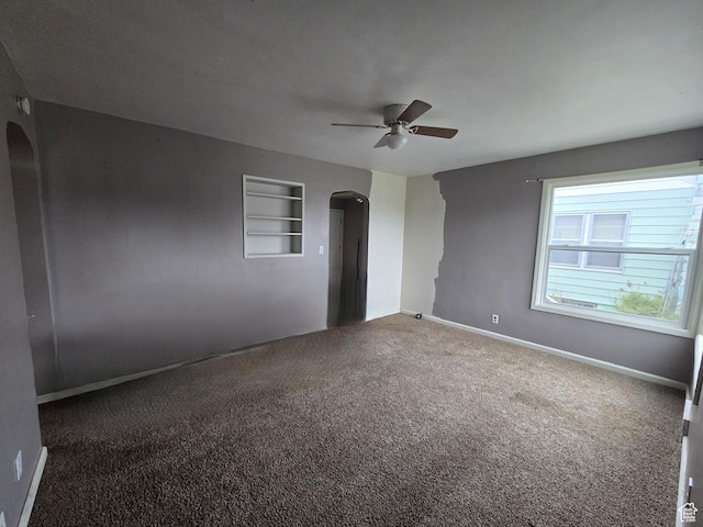 616 Jefferson St, Montpelier, ID 83254 - carpeted spare room with arched walkways, a ceiling fan, built in features, and baseboards