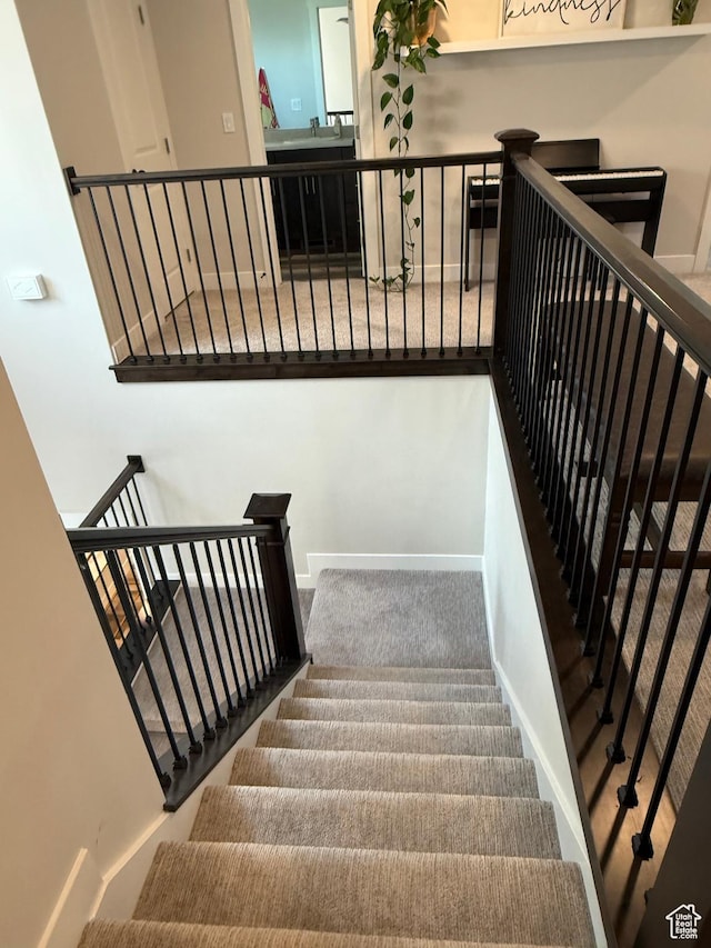 staircase with carpet flooring and baseboards