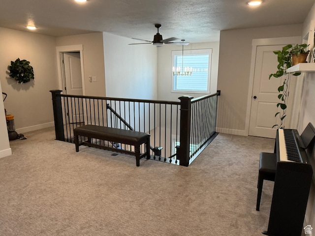 hall featuring baseboards, light carpet, an upstairs landing, and recessed lighting