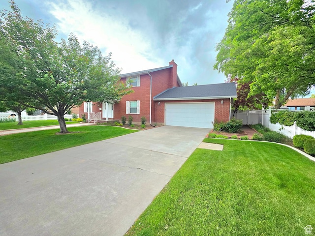 242 W 1100 S, Orem, UT 84058 - view of front of property featuring a garage, brick siding, concrete driveway, and a chimney