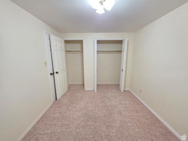 242 W 1100 S, Orem, UT 84058 - unfurnished bedroom with two closets, light carpet, and baseboards