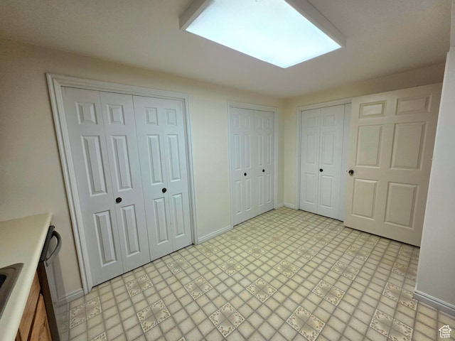 242 W 1100 S, Orem, UT 84058 - unfurnished bedroom with multiple closets, baseboards, and a sink