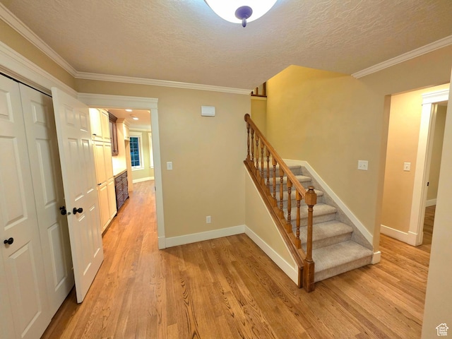 242 W 1100 S, Orem, UT 84058 - stairway featuring wood finished floors, crown molding, a textured ceiling, and baseboards