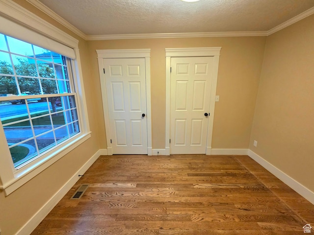 242 W 1100 S, Orem, UT 84058 - spare room with wood finished floors, crown molding, a textured ceiling, and baseboards