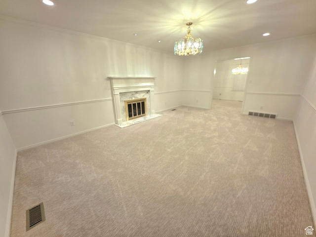 242 W 1100 S, Orem, UT 84058 - unfurnished living room featuring a chandelier, recessed lighting, light carpet, a high end fireplace, and baseboards