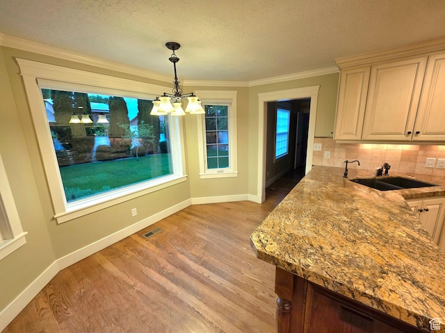 242 W 1100 S, Orem, UT 84058 - dining room with a chandelier, light wood-type flooring, baseboards, ornamental molding, and a textured ceiling