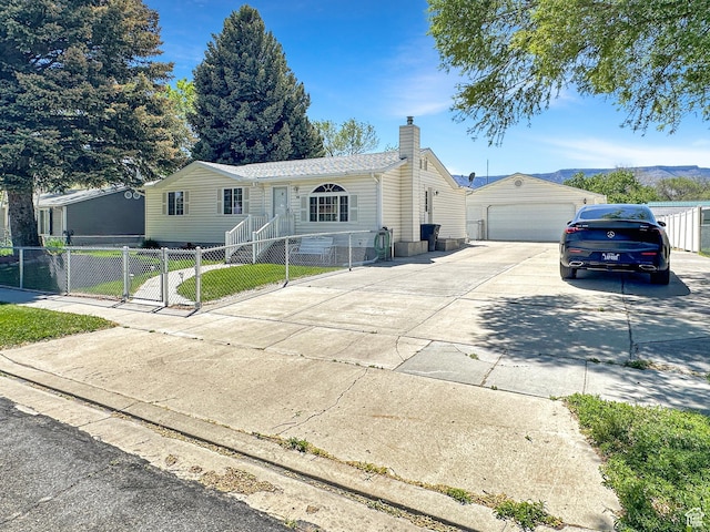 415 N Cedar Vw, Orangeville, UT 84537 - view of front of house featuring a chimney, an outdoor structure, a fenced front yard, and a garage