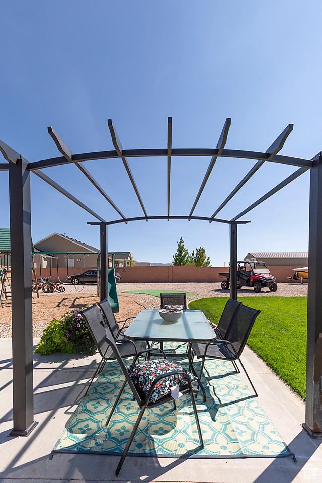 1136 S 4425 W, Cedar City, UT 84720 - fenced backyard featuring a patio, outdoor dining area, and glass enclosure