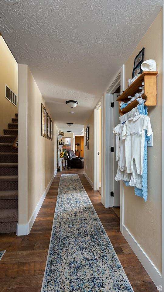 1136 S 4425 W, Cedar City, UT 84720 - hall featuring baseboards, stairs, a textured ceiling, and dark wood-type flooring