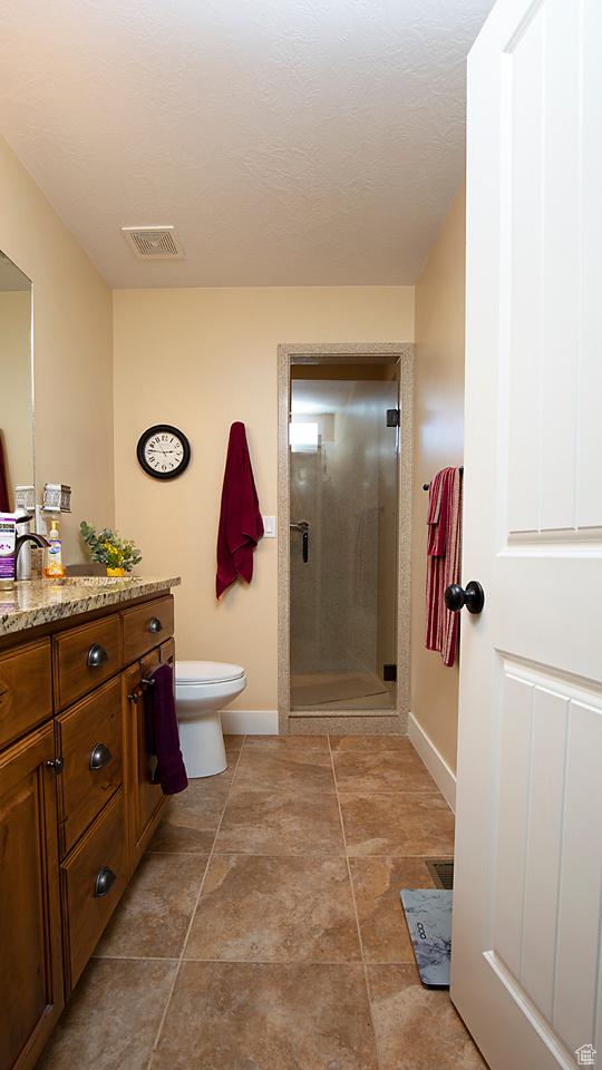 1136 S 4425 W, Cedar City, UT 84720 - bathroom with a shower stall, baseboards, vanity, and toilet