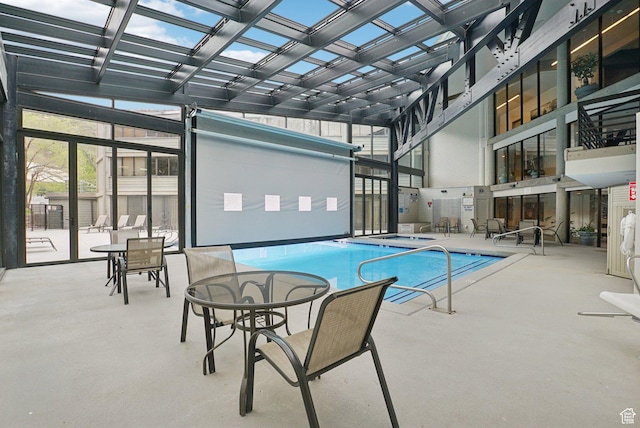 indoor pool featuring a pergola and a patio area