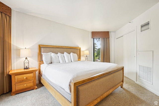bedroom with light colored carpet and a closet