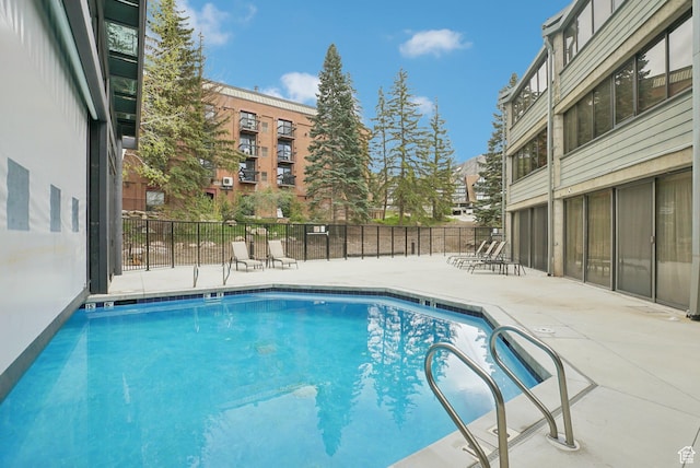 community pool with a patio area