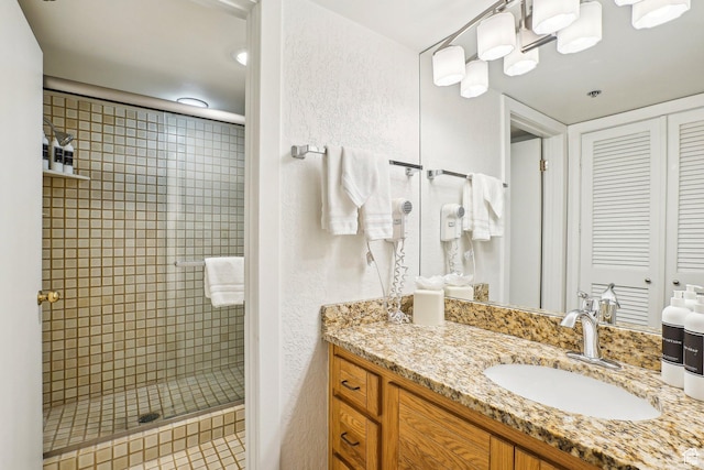 full bath featuring a stall shower and vanity