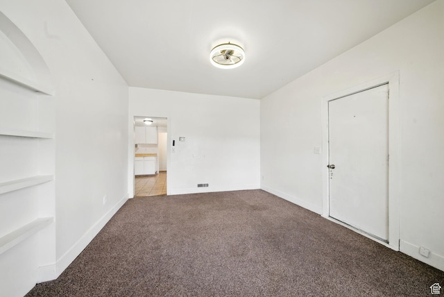 653 E Hollywood Ave, Salt Lake City, UT 84105 - unfurnished room with carpet flooring, built in shelves, and baseboards