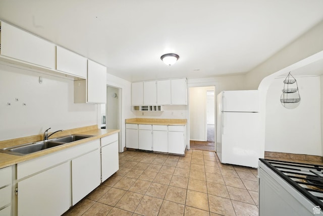 653 E Hollywood Ave, Salt Lake City, UT 84105 - kitchen with white appliances, a sink, white cabinets, and light tile patterned flooring