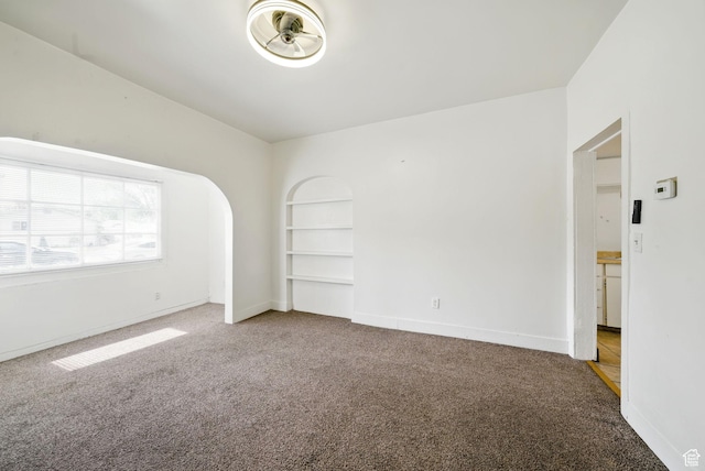 653 E Hollywood Ave, Salt Lake City, UT 84105 - unfurnished room featuring carpet floors, built in shelves, and baseboards