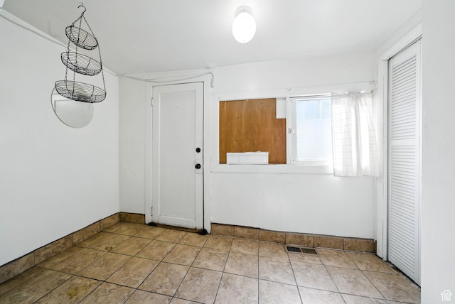 653 E Hollywood Ave, Salt Lake City, UT 84105 - foyer entrance with baseboards and tile patterned floors