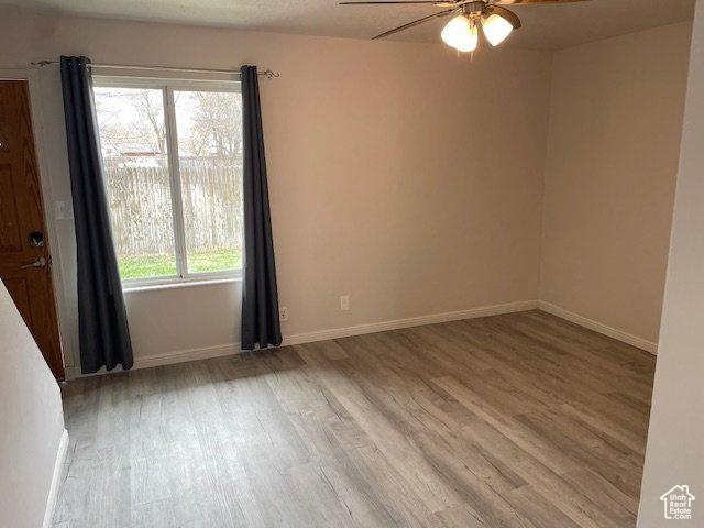 285 W 600 N Unit 3, Logan, UT 84321 - unfurnished room with wood finished floors, ceiling fan, and baseboards