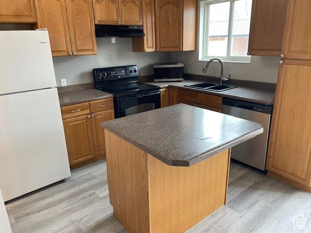 285 W 600 N Unit 3, Logan, UT 84321 - kitchen featuring freestanding refrigerator, stainless steel dishwasher, black range with electric stovetop, under cabinet range hood, and a sink