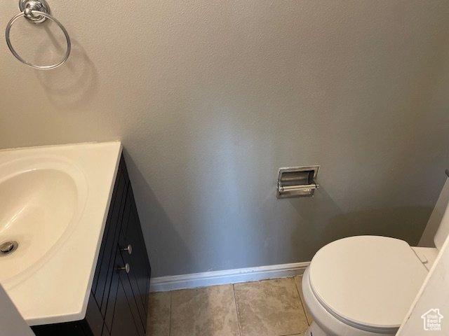 285 W 600 N Unit 3, Logan, UT 84321 - bathroom with baseboards, vanity, tile patterned floors, and toilet