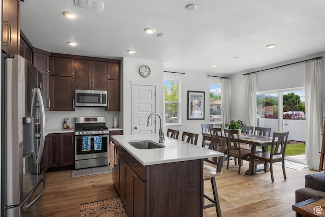 703 W Swinley Dr, Murray, UT 84123 - kitchen with stainless steel appliances, a sink, light countertops, healthy amount of natural light, and recessed lighting