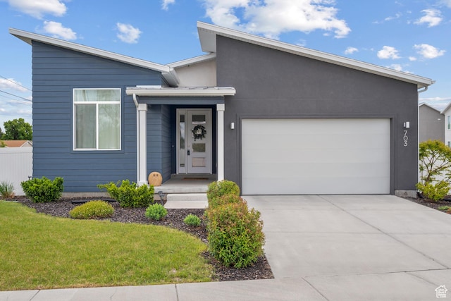703 W Swinley Dr, Murray, UT 84123 - view of front of home with concrete driveway, a garage, and a front lawn