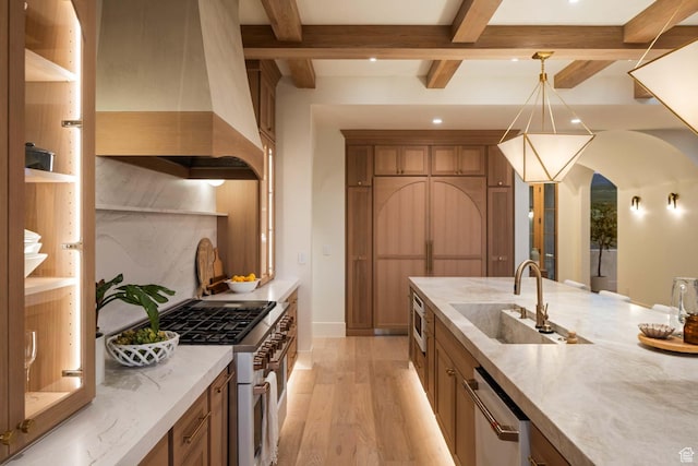 1171 E 430 S, Santaquin, UT 84655 - kitchen featuring island exhaust hood, appliances with stainless steel finishes, a sink, light wood finished floors, and arched walkways