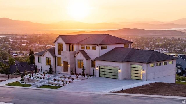 1171 E 430 S, Santaquin, UT 84655 - view of front of property featuring an attached garage, concrete driveway, a mountain view, stucco siding, and a shingled roof