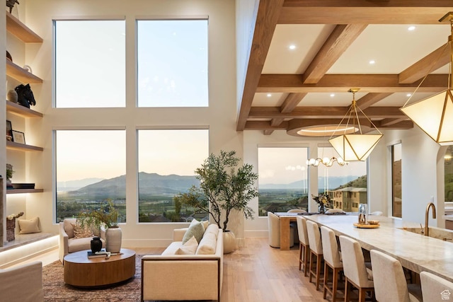 1171 E 430 S, Santaquin, UT 84655 - living area featuring light wood-style floors, a mountain view, healthy amount of natural light, beamed ceiling, and a chandelier
