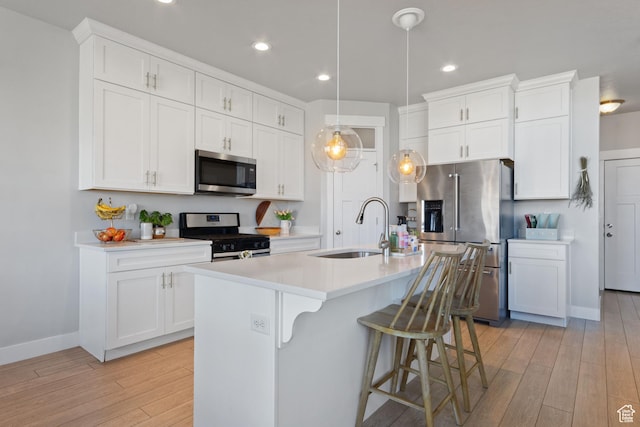 14949 S Billings Dr W Unit 119, Herriman, UT 84096 - kitchen with appliances with stainless steel finishes, a sink, light wood-type flooring, light countertops, and white cabinets