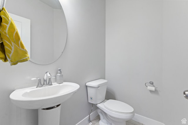 14949 S Billings Dr W Unit 119, Herriman, UT 84096 - bathroom with baseboards, toilet, tile patterned floors, and a sink