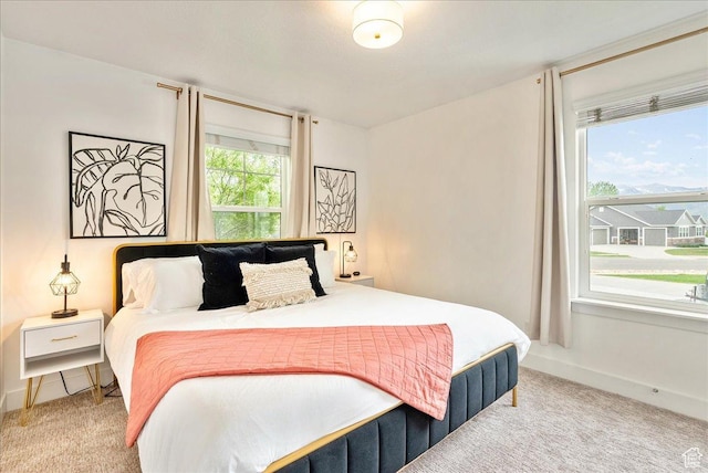 carpeted bedroom featuring baseboards