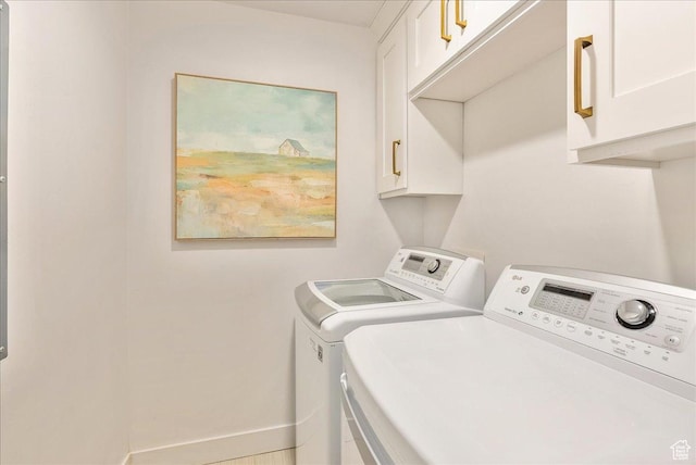 laundry area with washer and dryer and cabinet space