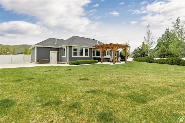 rear view of property featuring a pergola and a patio area