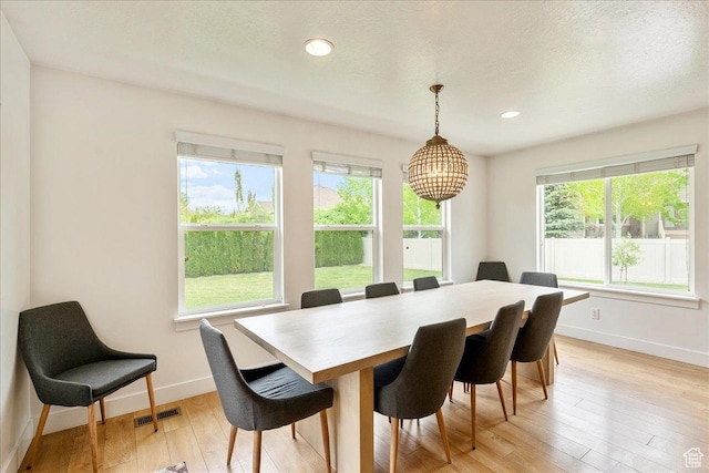 dining space with healthy amount of natural light, baseboards, light wood-type flooring, and recessed lighting