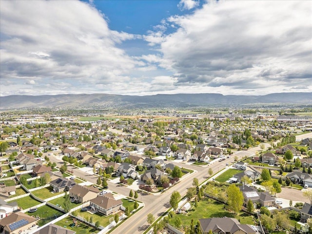 view of property location with a mountain backdrop and nearby suburban area