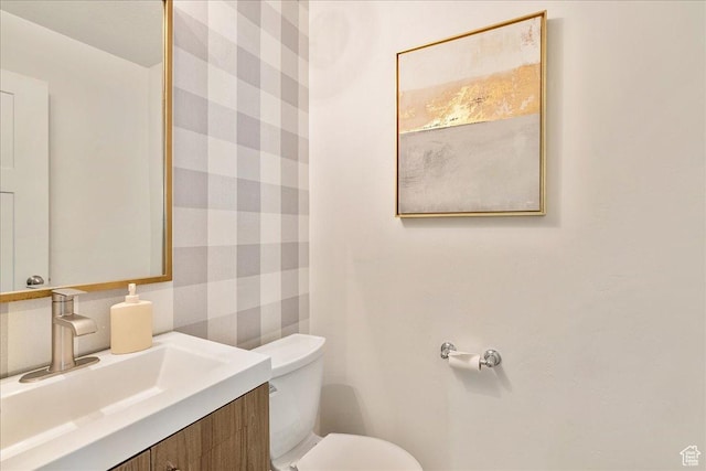 half bathroom featuring toilet and vanity