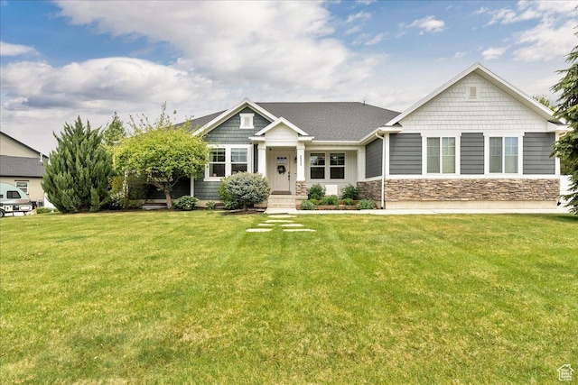craftsman house with a front lawn and stone siding