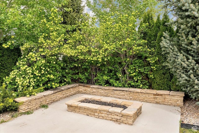 view of patio / terrace featuring an outdoor fire pit