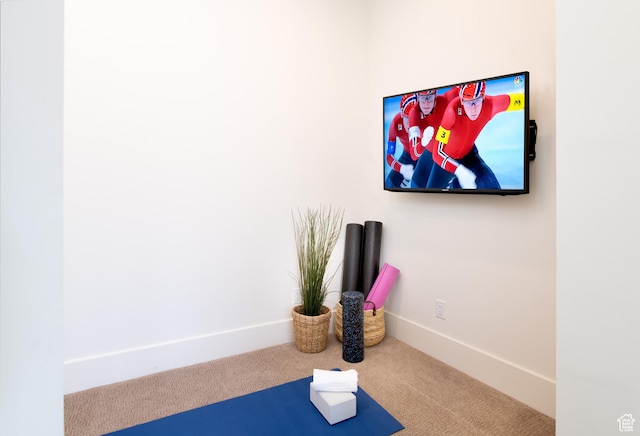 workout area with carpet and baseboards