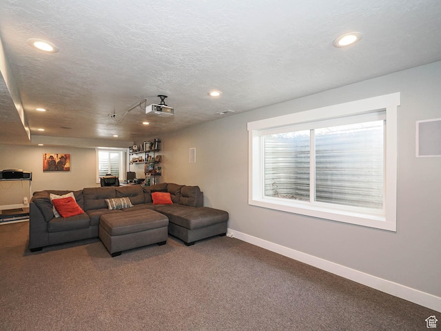 carpeted living area featuring baseboards, recessed lighting, and a textured ceiling