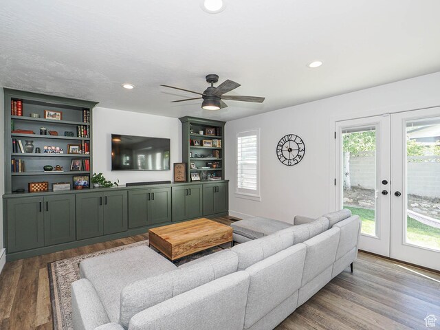 living room featuring french doors, plenty of natural light, wood finished floors, a ceiling fan, and recessed lighting
