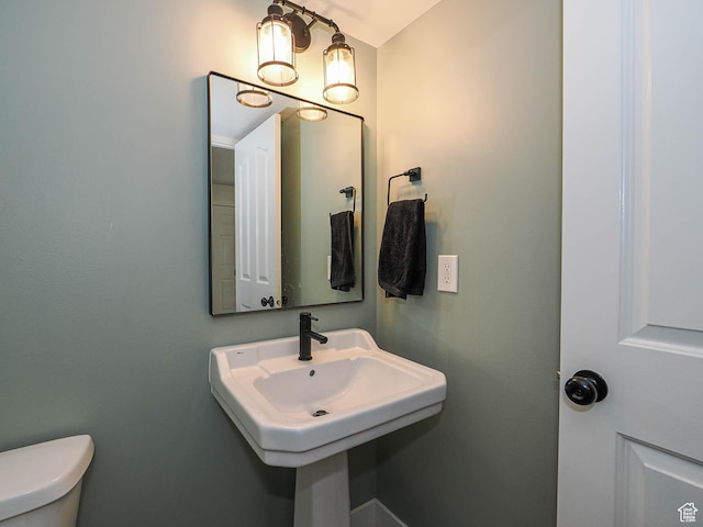 bathroom with toilet and a sink