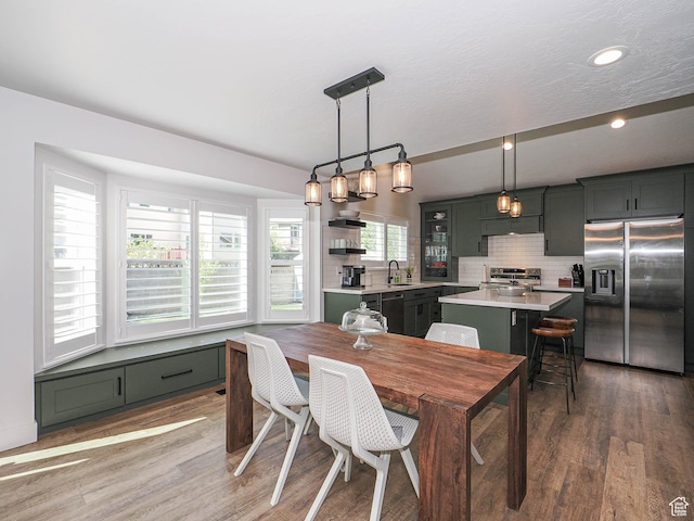 dining room featuring light wood finished floors and recessed lighting