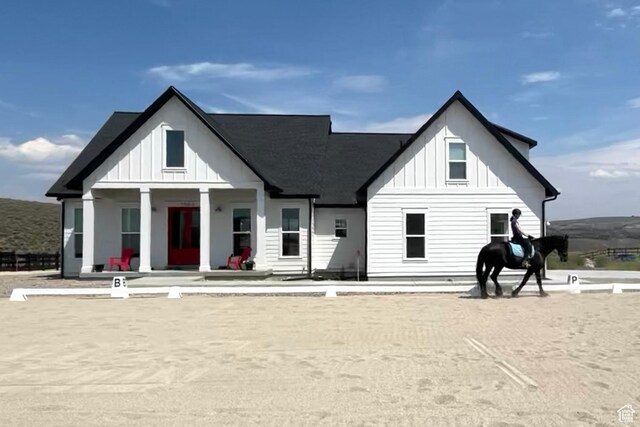 7664 Whileaway E, Park City, UT 84098 - rear view of house featuring board and batten siding and covered porch