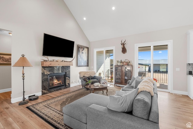 7664 Whileaway E, Park City, UT 84098 - living room featuring light wood-style flooring, a fireplace, high vaulted ceiling, and recessed lighting