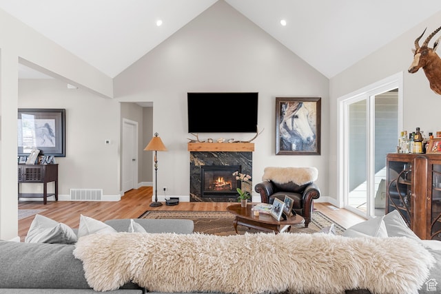 7664 Whileaway E, Park City, UT 84098 - living area featuring a premium fireplace, light wood-style flooring, high vaulted ceiling, and recessed lighting