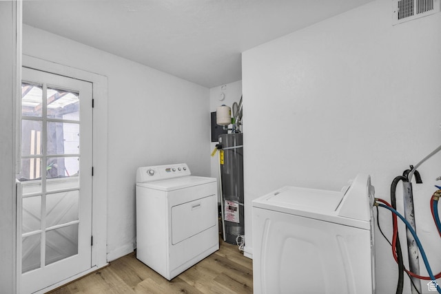 4587 W 5100 S, Kearns, UT 84118 - laundry area with washer and clothes dryer, light wood finished floors, and water heater